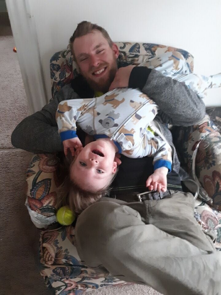 Aric Michael Lantz, 28, plays with his son Carter Thomas Lantz.